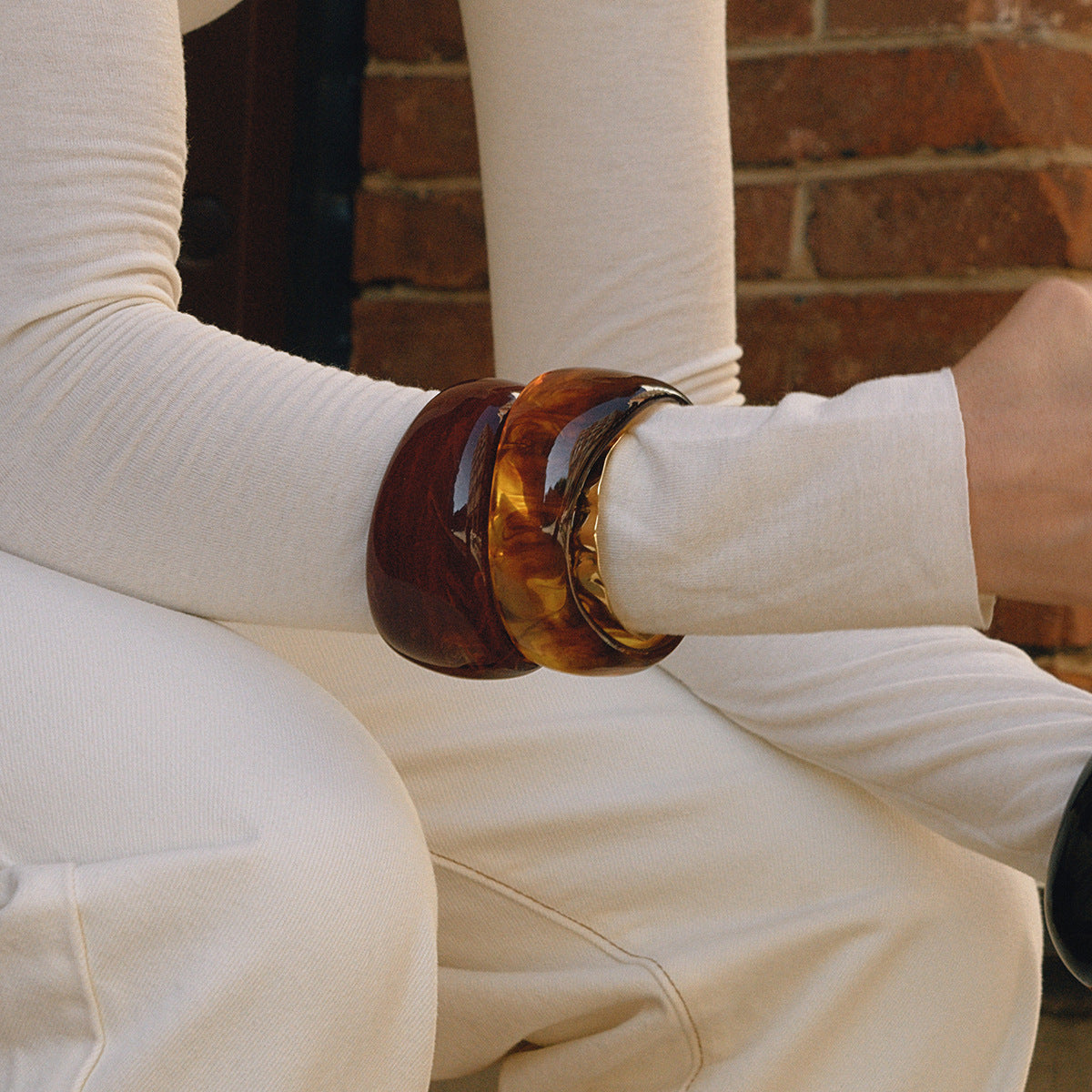 Brown resin bangle bracelet set for women with glossy finish stacked on wrist