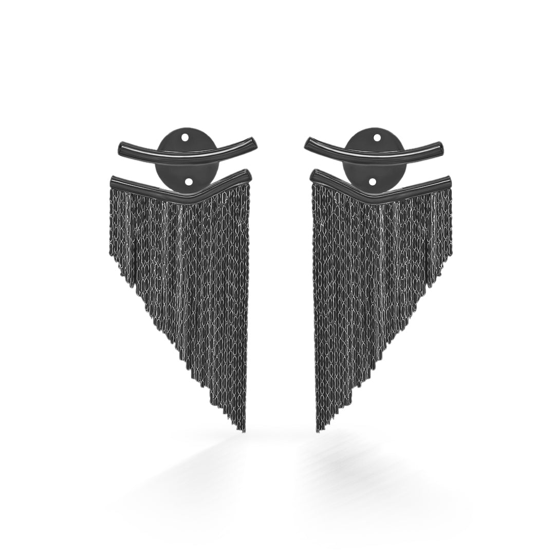 A person wearing a tassel dangler earrings for women, with the earring focused on the lower part, displaying a silver color with small black tassel details.
