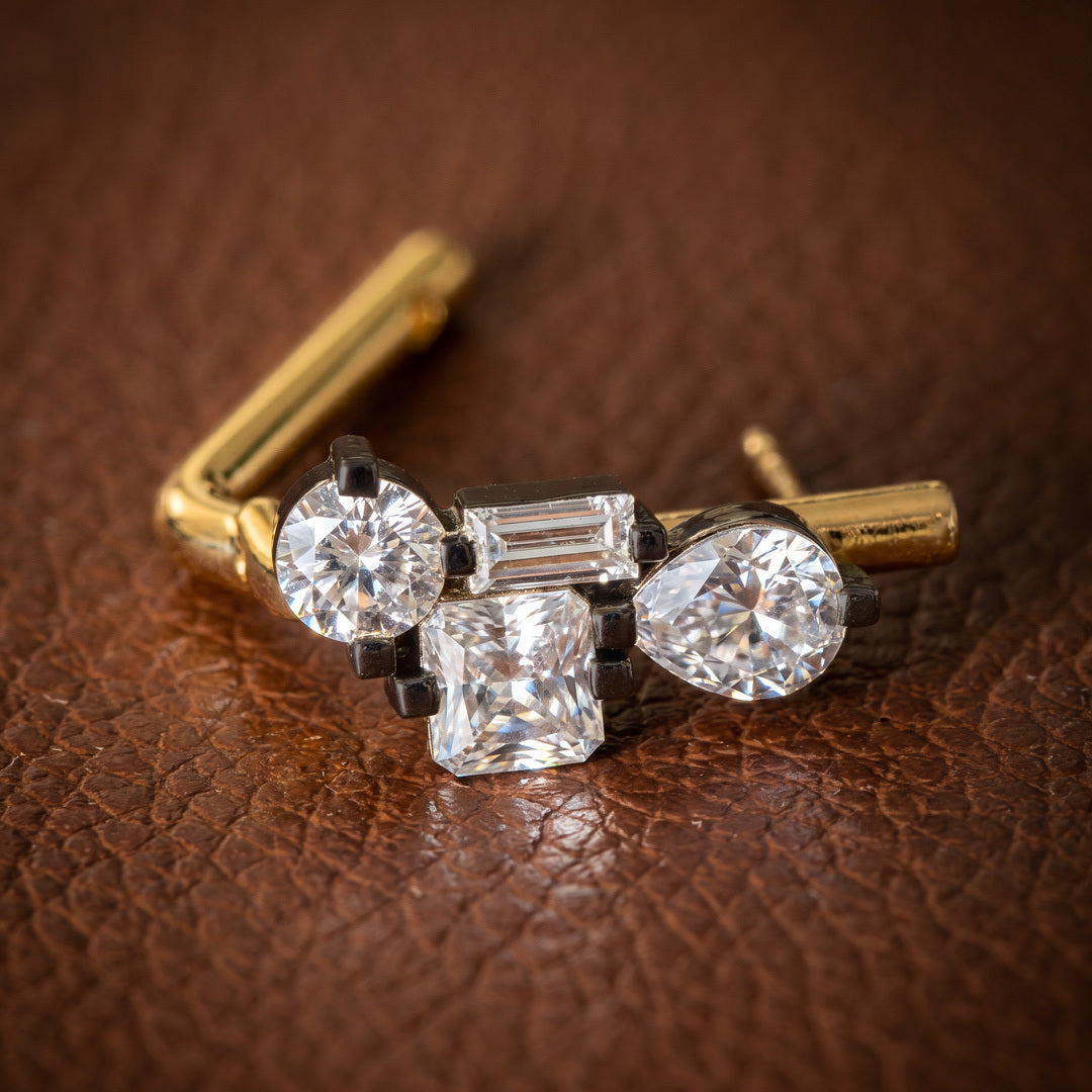 Front view of Harper gold and silver-tone crystal cluster huggie earrings