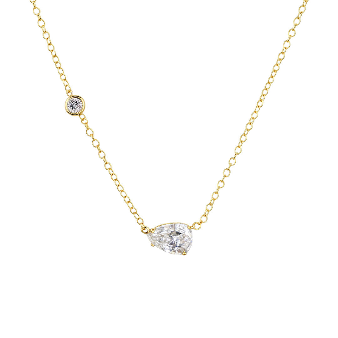 Gold necklace with two diamond pendants on a white background