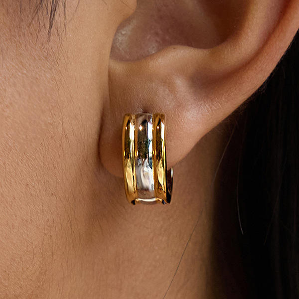 Gold hoop earrings for women  worn on an ear with a blurred background