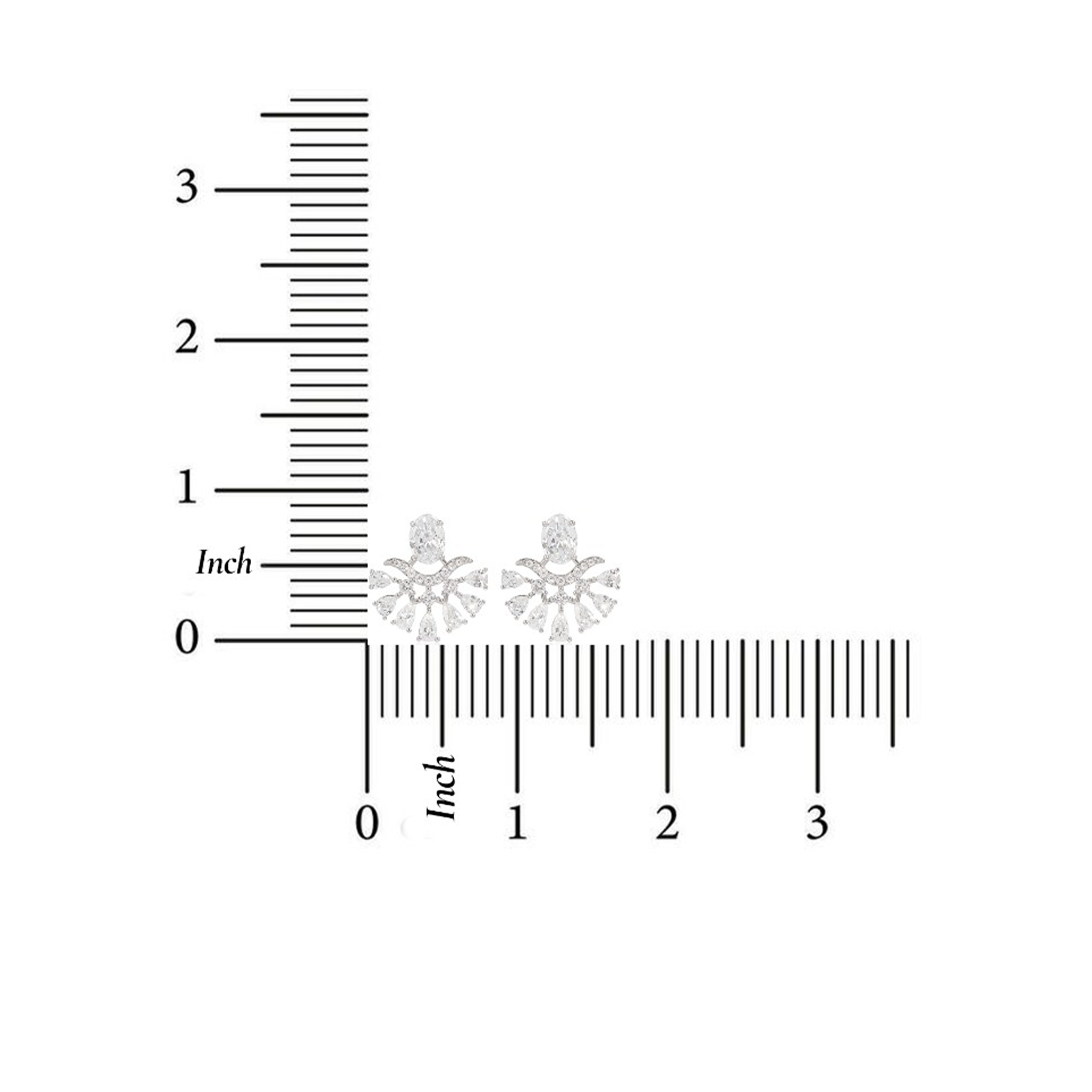 Two small diamond earrings on a ruler for scale