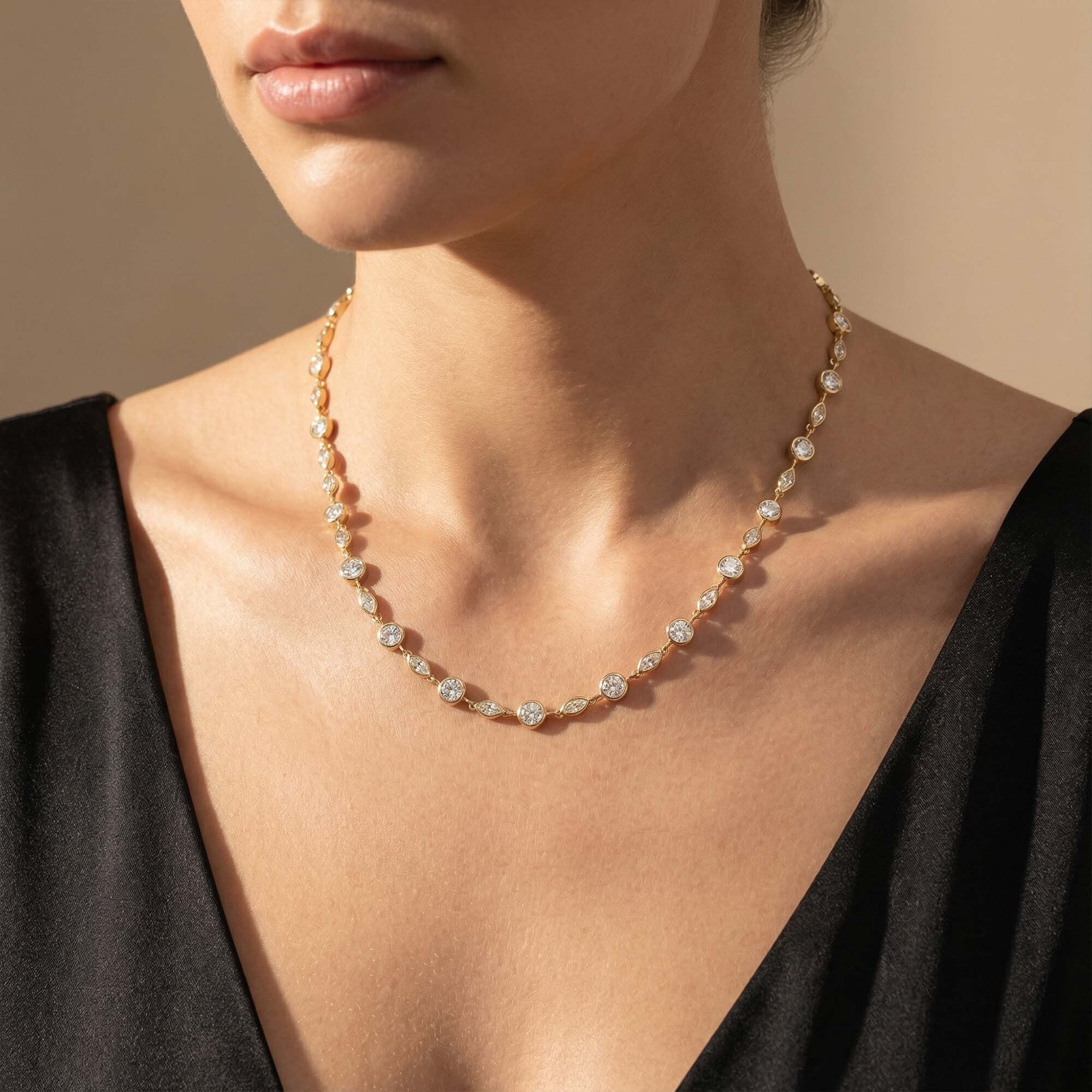 Close-up of a person wearing a delicate necklace with a neutral background