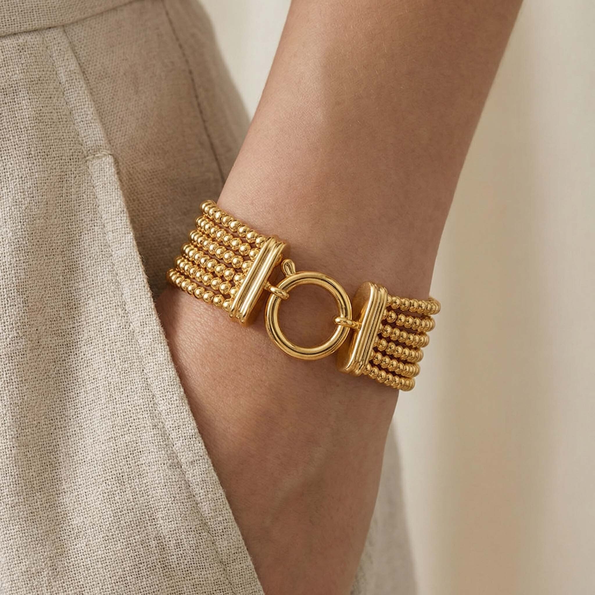 Gold daily wear bracelet for women with multi strand beaded design 