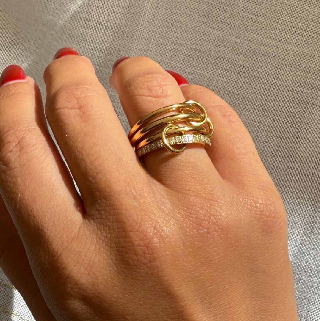 Gold stacked rings for women with linked band design and crystal accent detail
