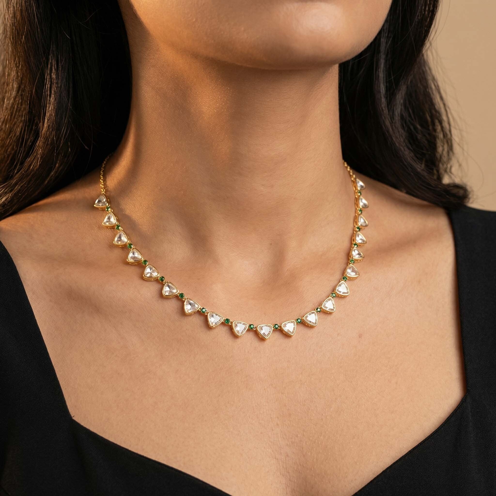 Gold heart crystal necklace for women with green stone accents, elegant statement necklace close-up