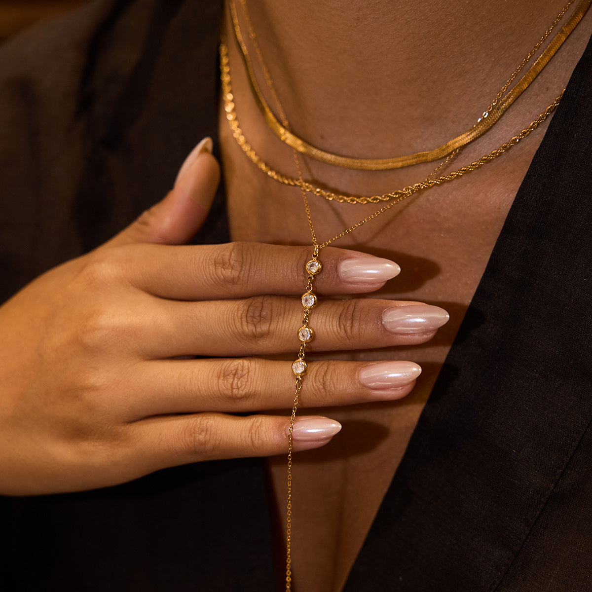 Gold chain neckalces for women  worn by a person with a neutral background