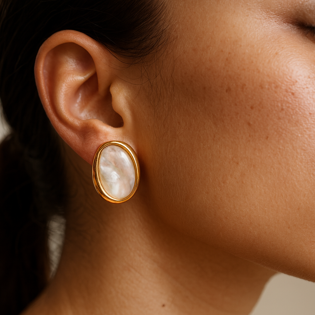 gold oval pearl stud earrings for women elegant daily wear jewelry close up
