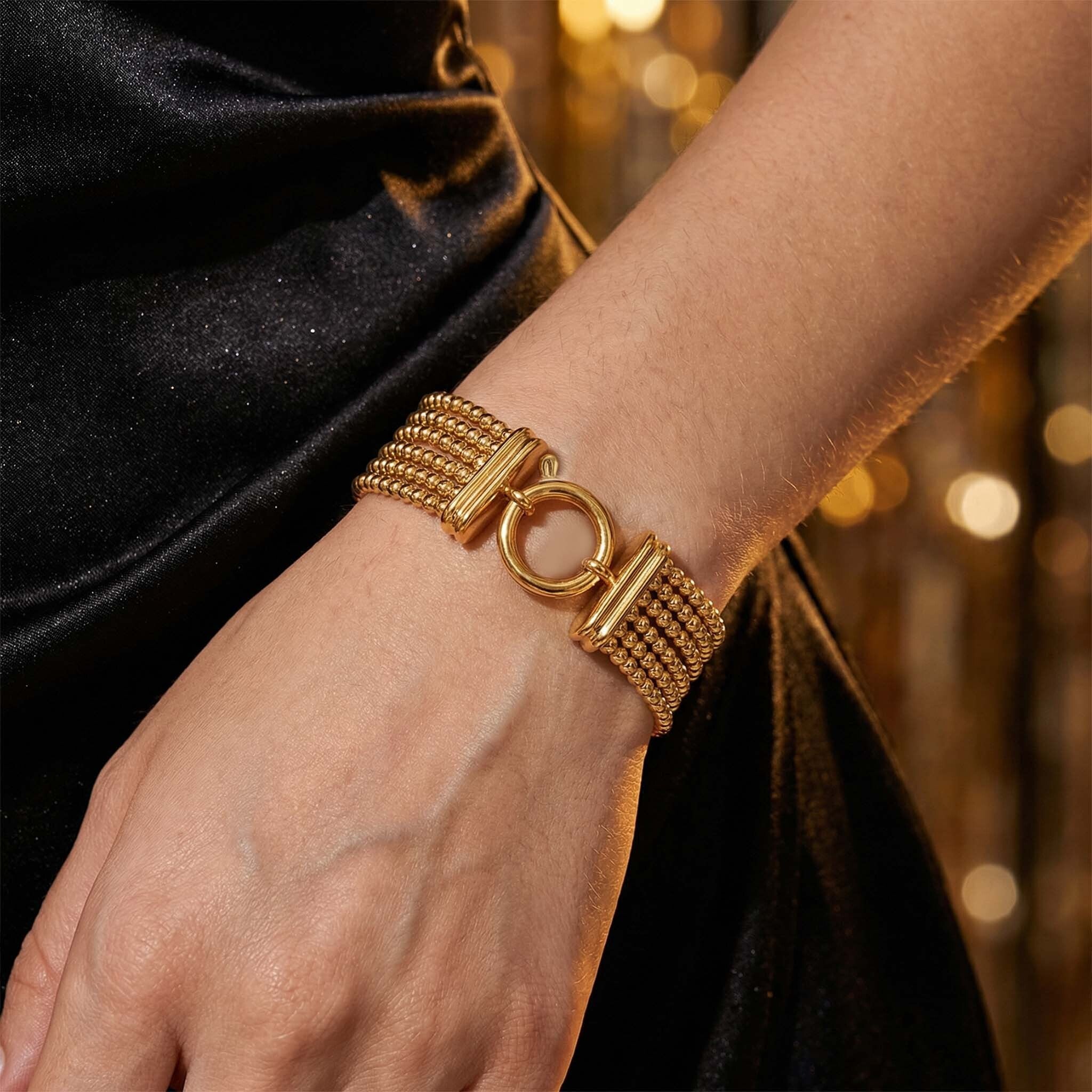 Gold party wear bracelet for women with bold multi strand bead pattern