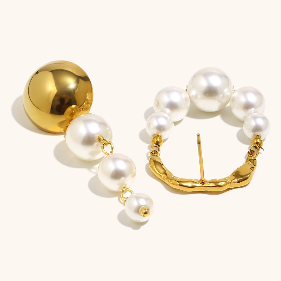 Gold and pearl earrings on a white background