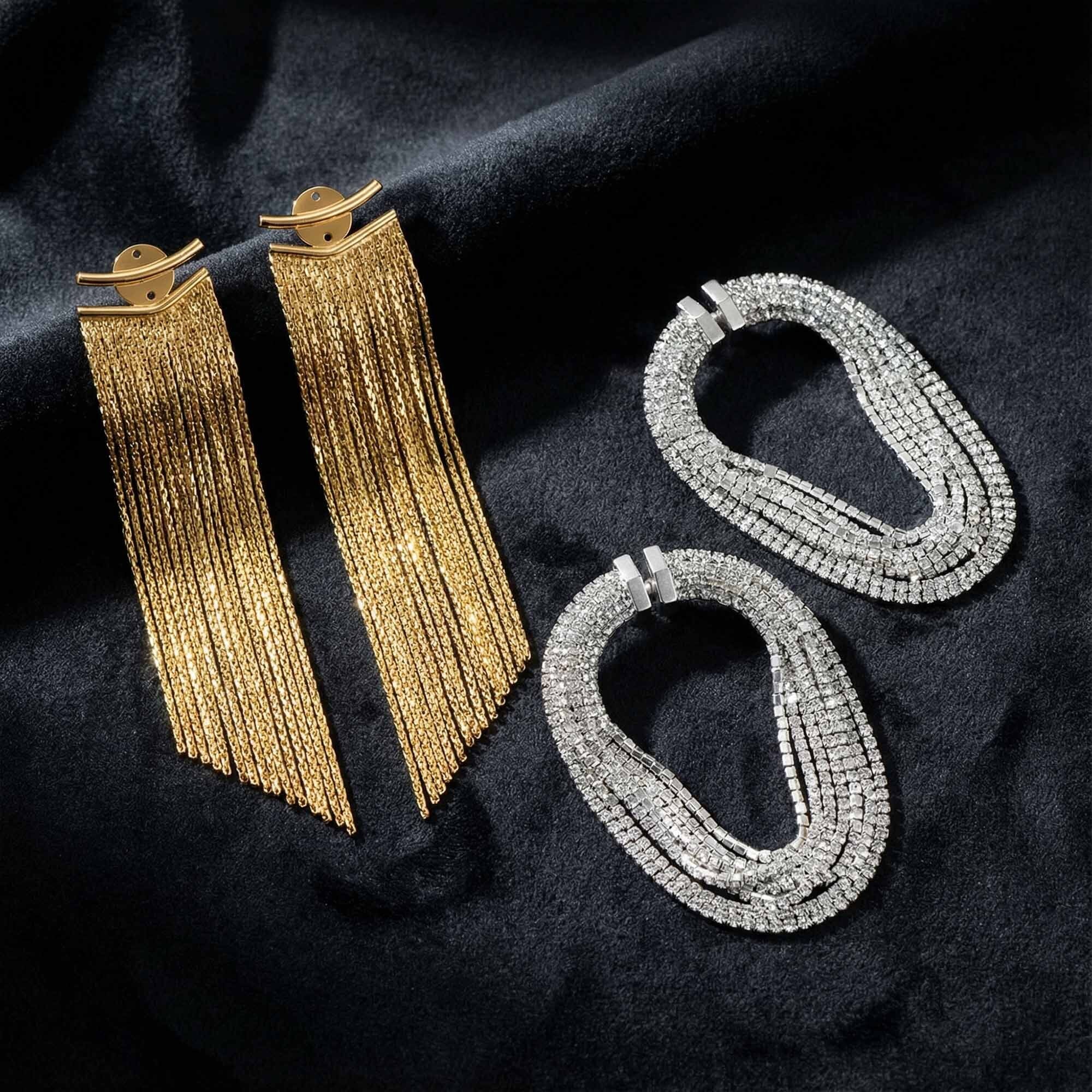 Gold and silver hoop earrings on a dark fabric background