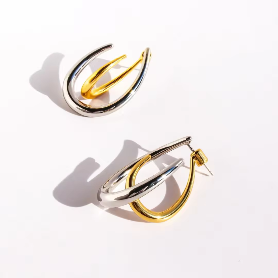 Gold and silver hoop earrings on a white background