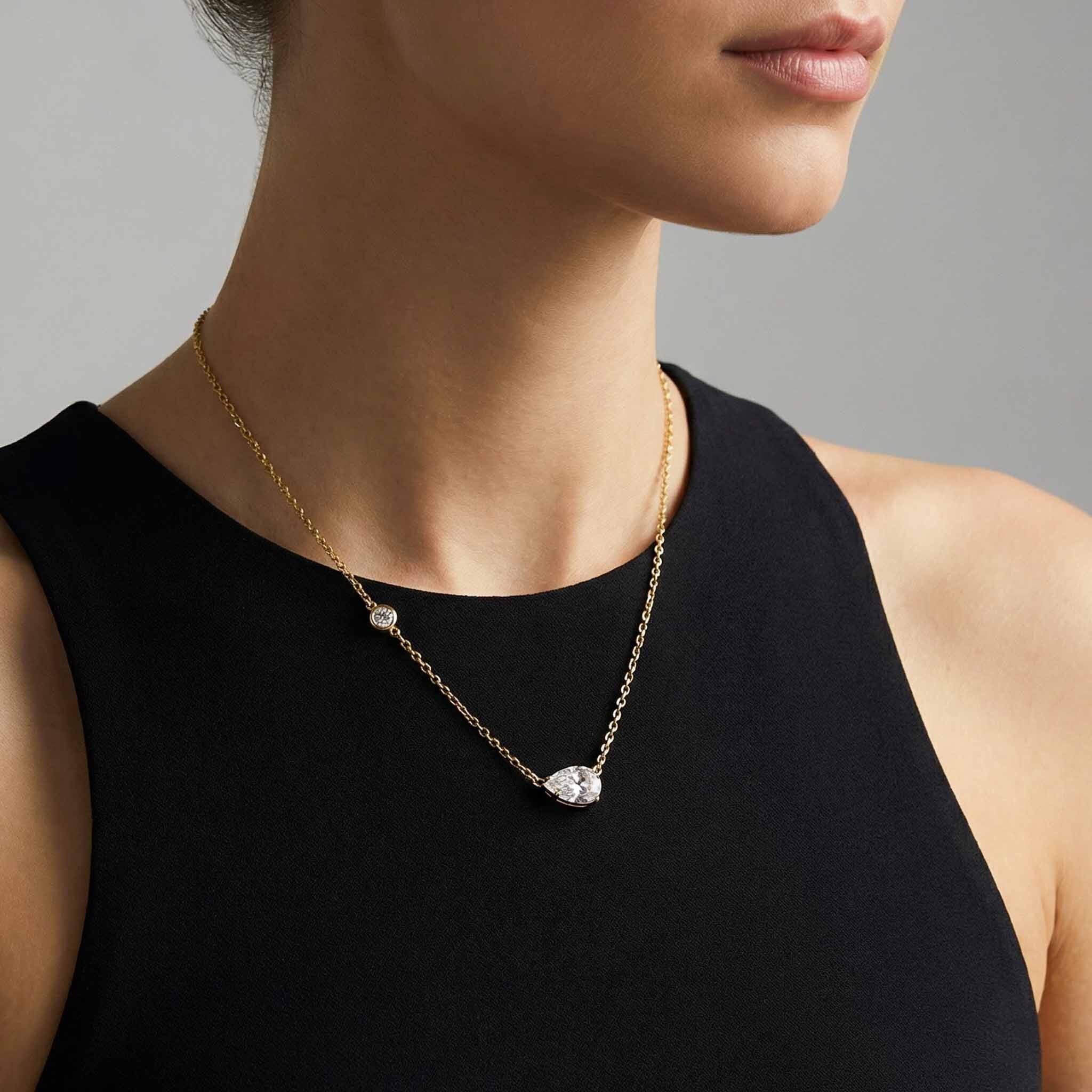 Necklace with a pendant worn by a person against a neutral background