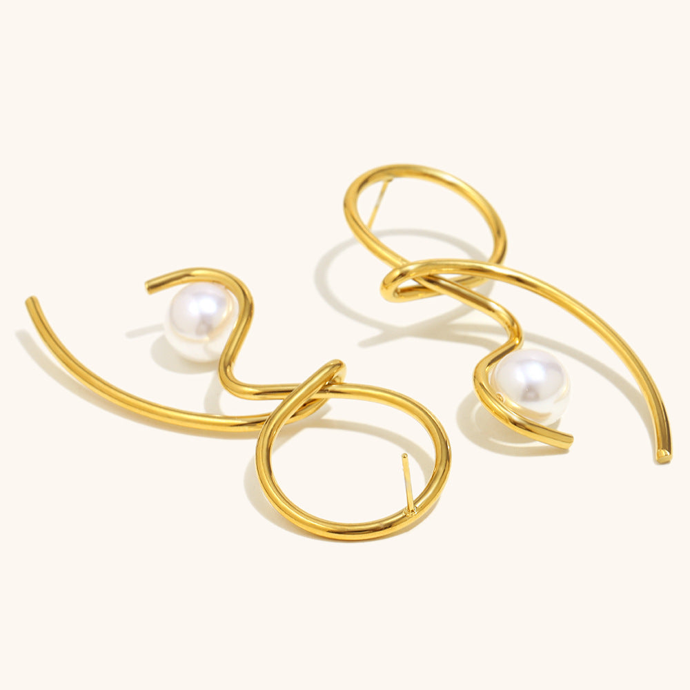 Gold hoop earrings with pearls on a white background