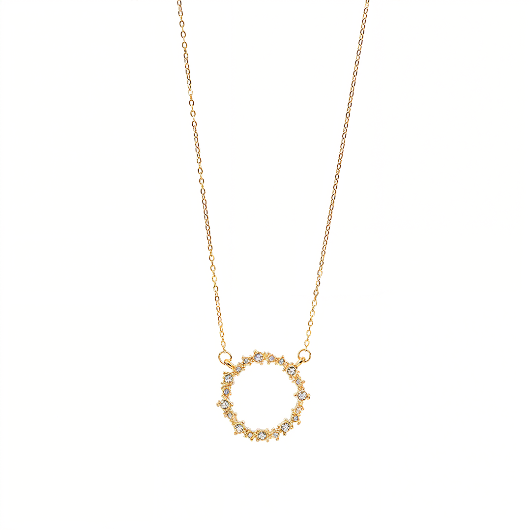 Gold necklace with a circular pendant on a white background