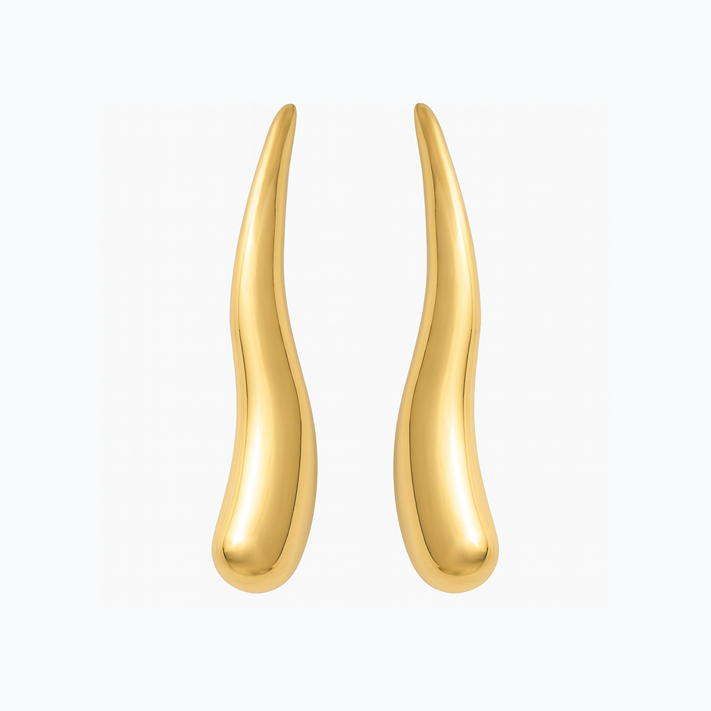 Gold earrings on a white background Party wear earrings for women