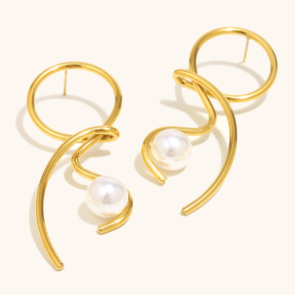 Gold earrings with pearl centers on a white background