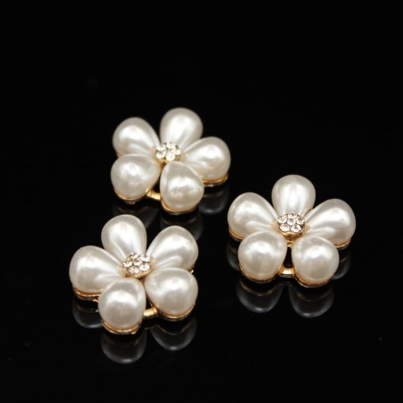 Three pearl flower-shaped Button on a black background