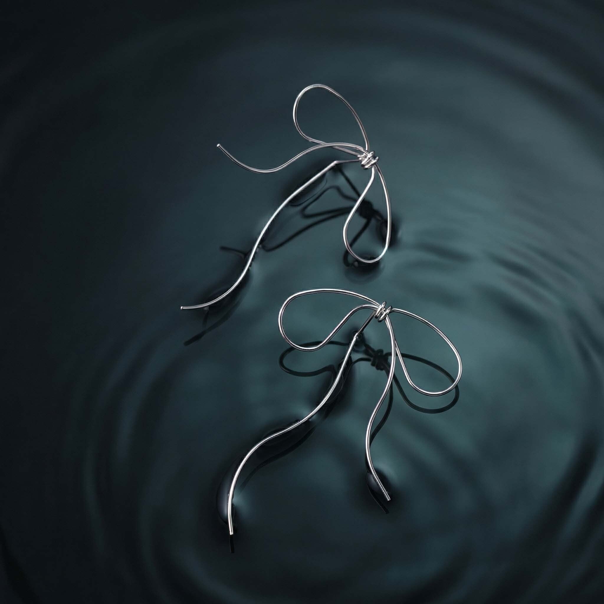 modern minimalist bow earrings for women with long dangling wire for chic everyday wear
