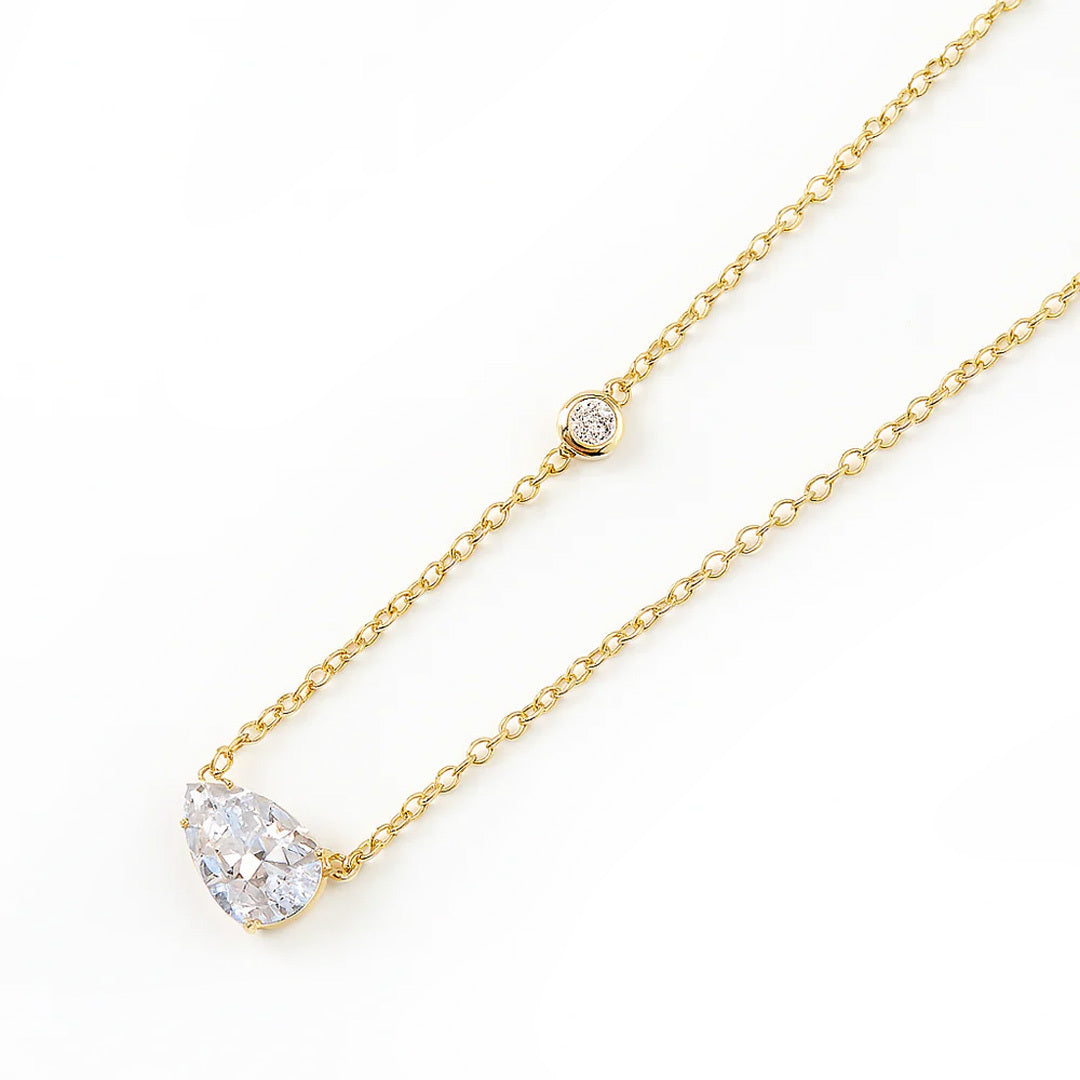 Gold necklaces for women with a heart-shaped diamond pendant on a white background