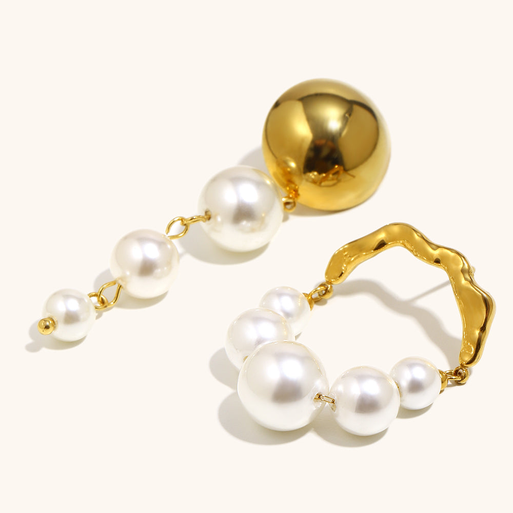 Gold and pearl earrings on a white background