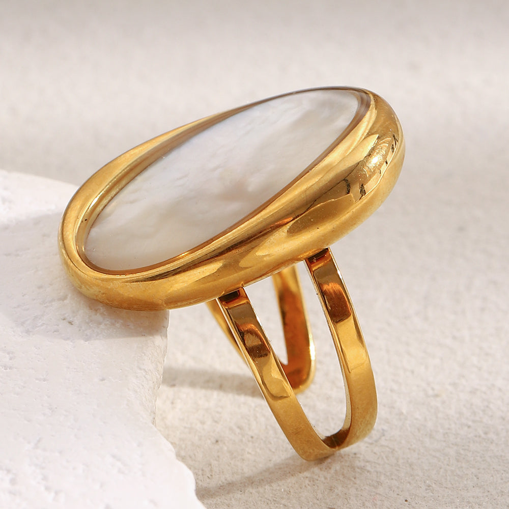 Gold ring on a textured white surface