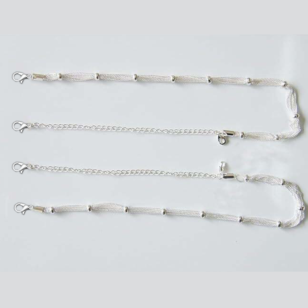 Set of silver chain strap  on a light gray background