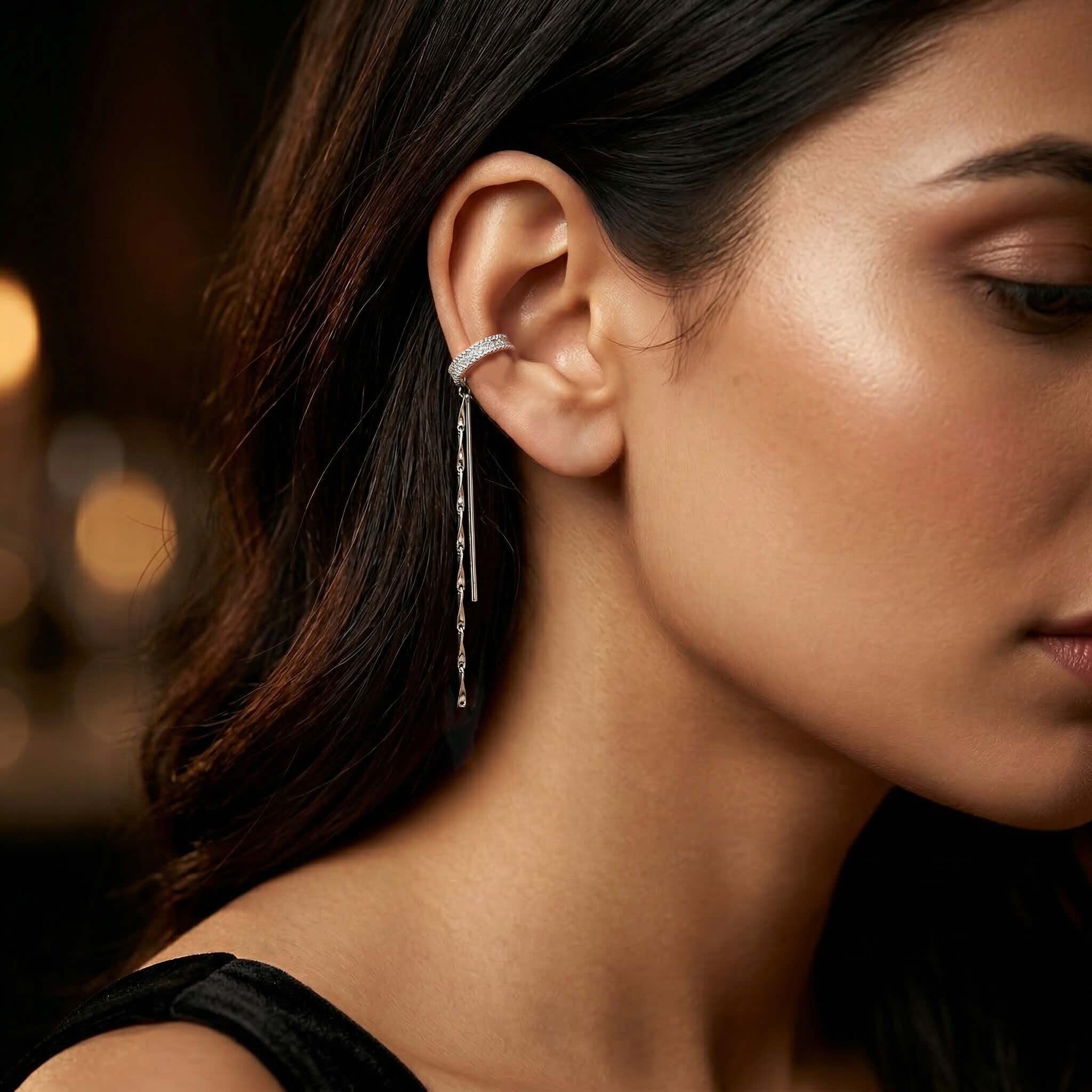 Close-up of a woman wearing a silver earring with a blurred background