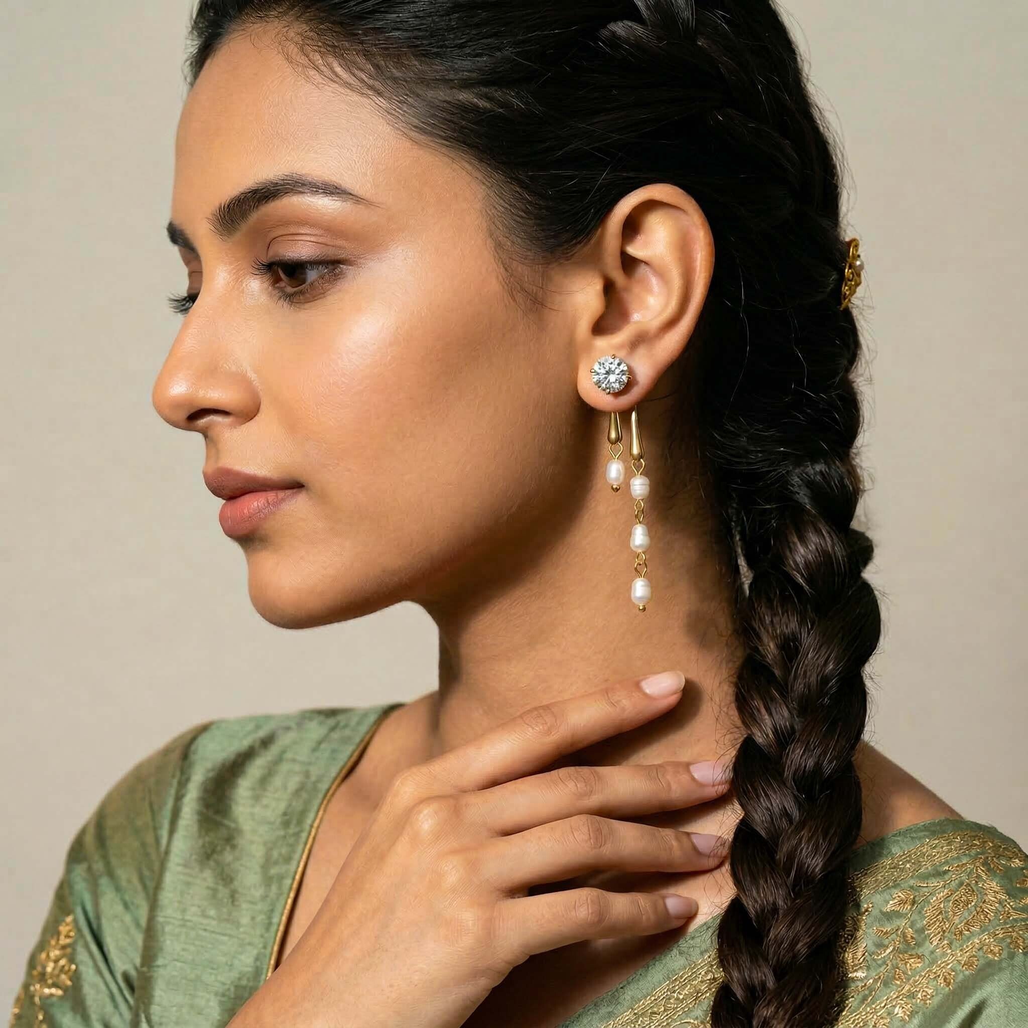Woman wearing earrings  for women with a green and gold traditional outfit