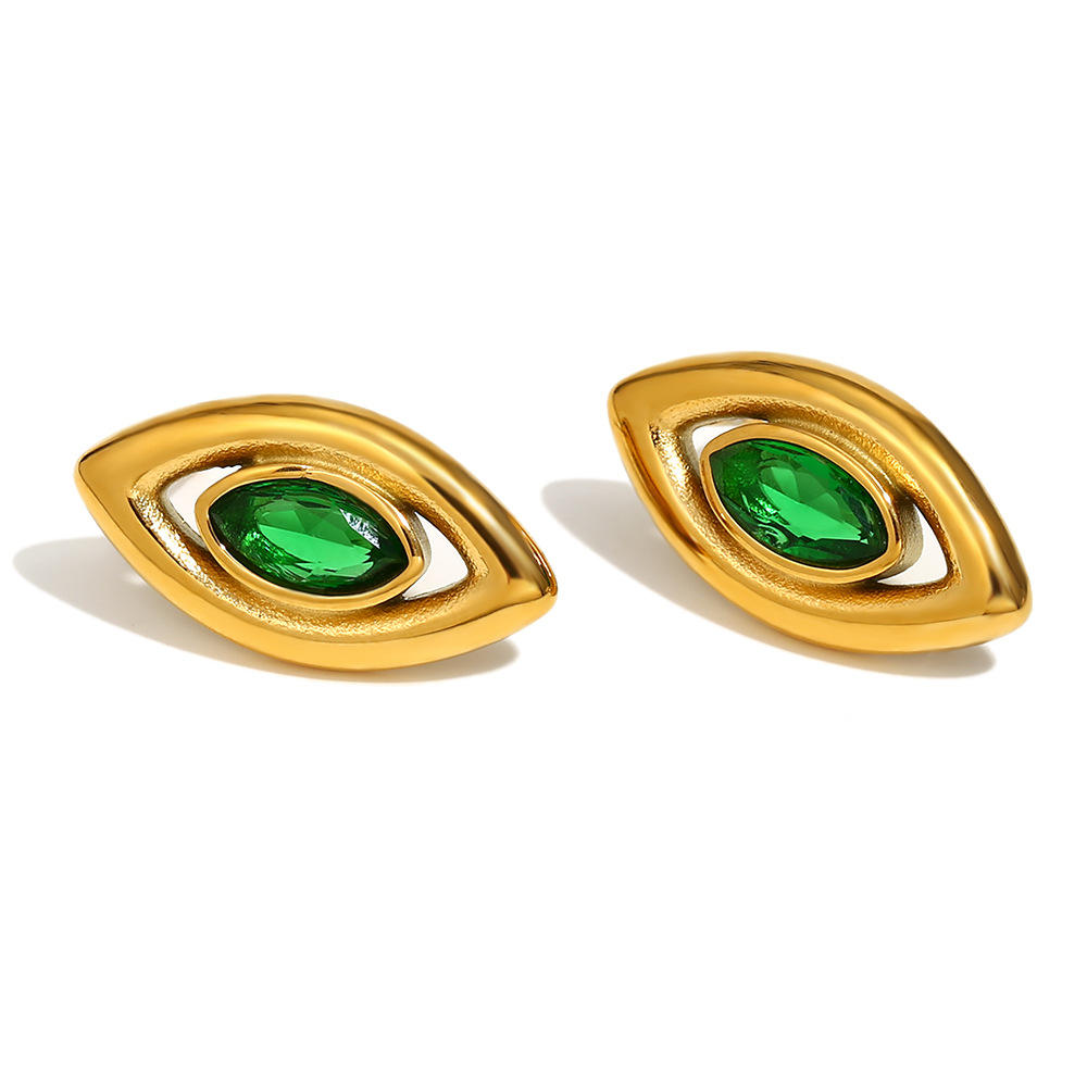 Gold earrings with green gemstones on a white background