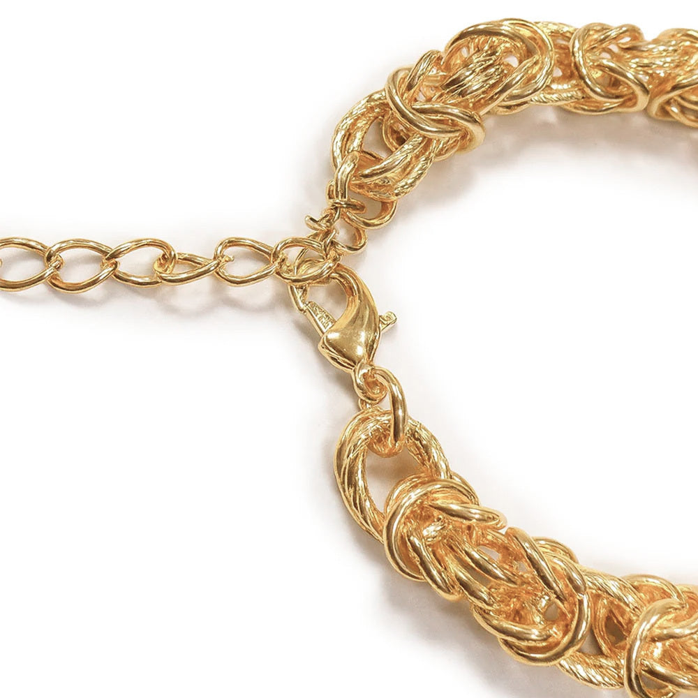 Chunky gold  chain bracelet with a twisted design and adjustable extender chain for a secure and flexible fit.