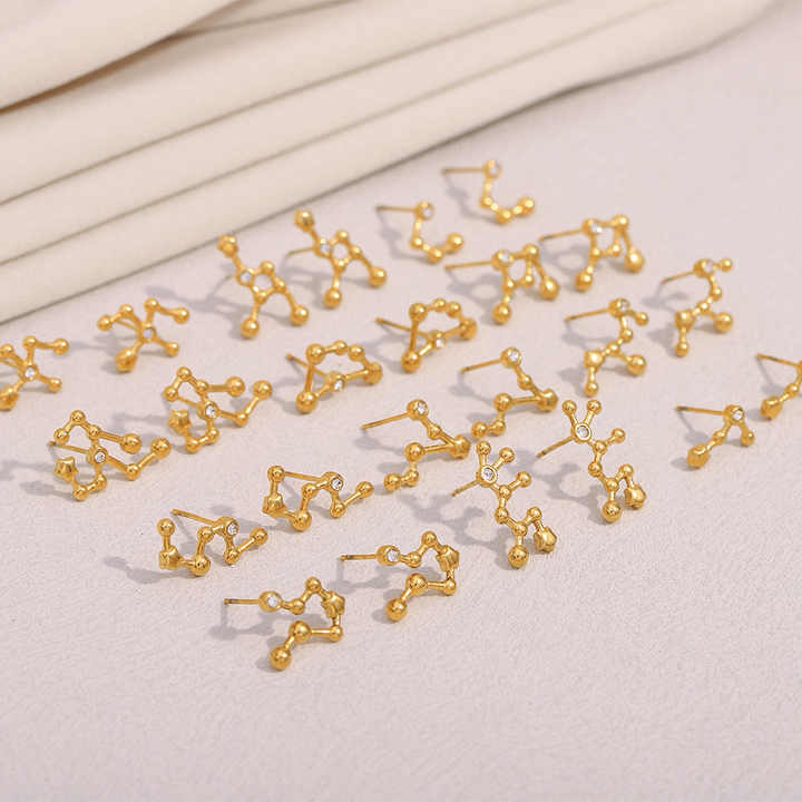 Gold molecular structure earrings for women  on a light background