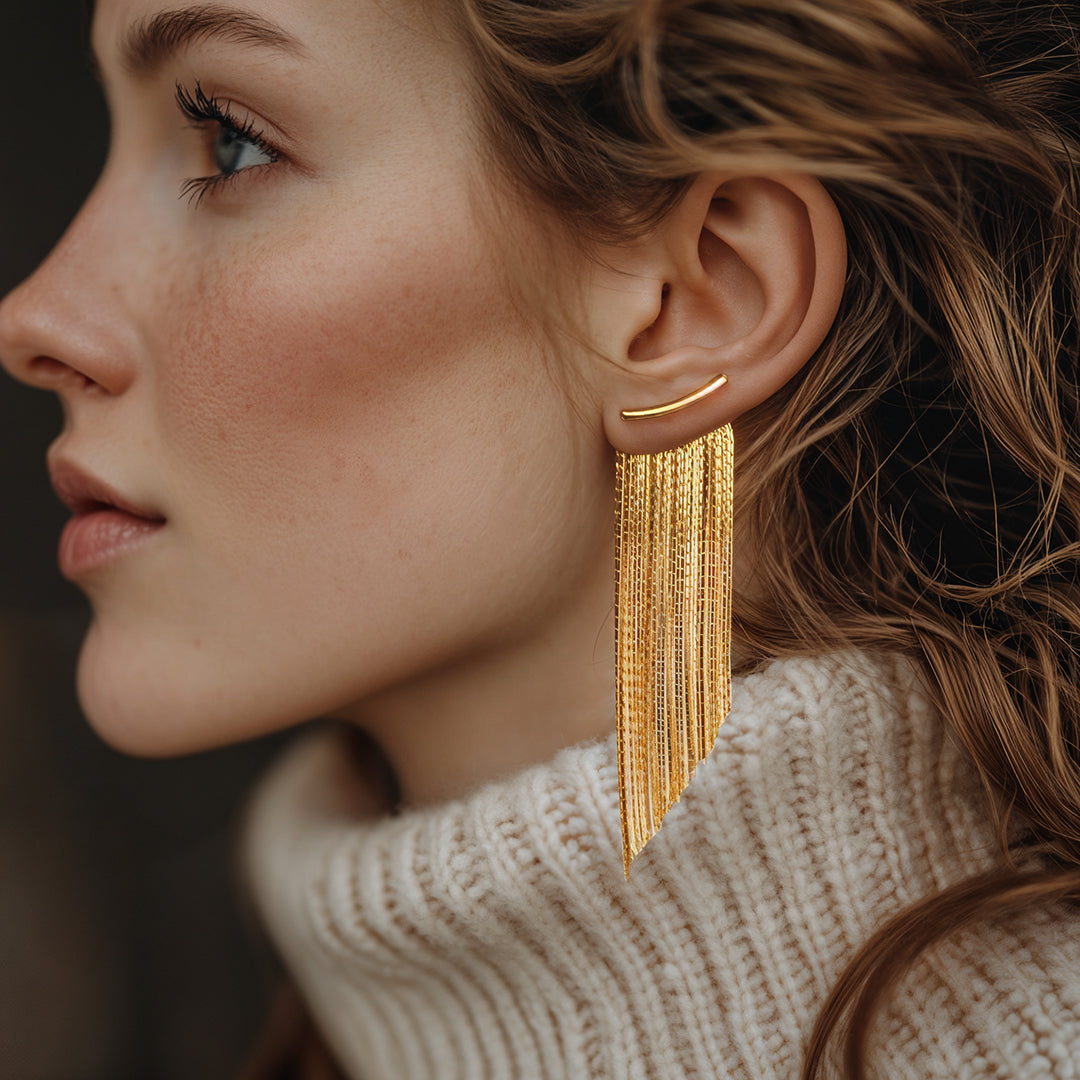 Gold metal earrings featuring fringes, showcasing a stylish and elegant design suitable for various occasions.