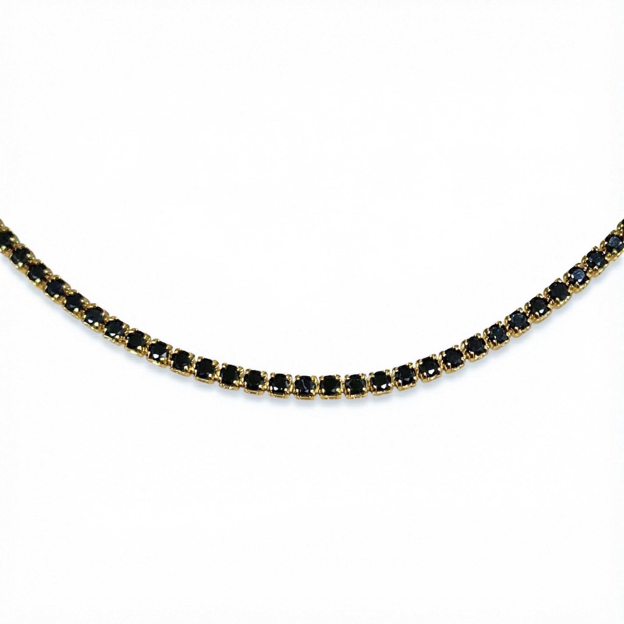 Gold necklace with black stones on a white background
