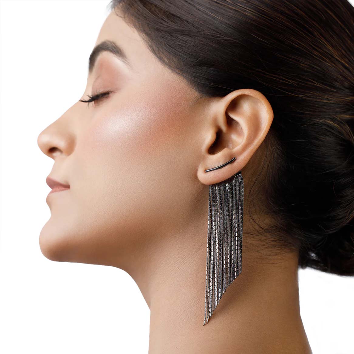 Close-up of a woman wearing a dangling earrings for women on a white background