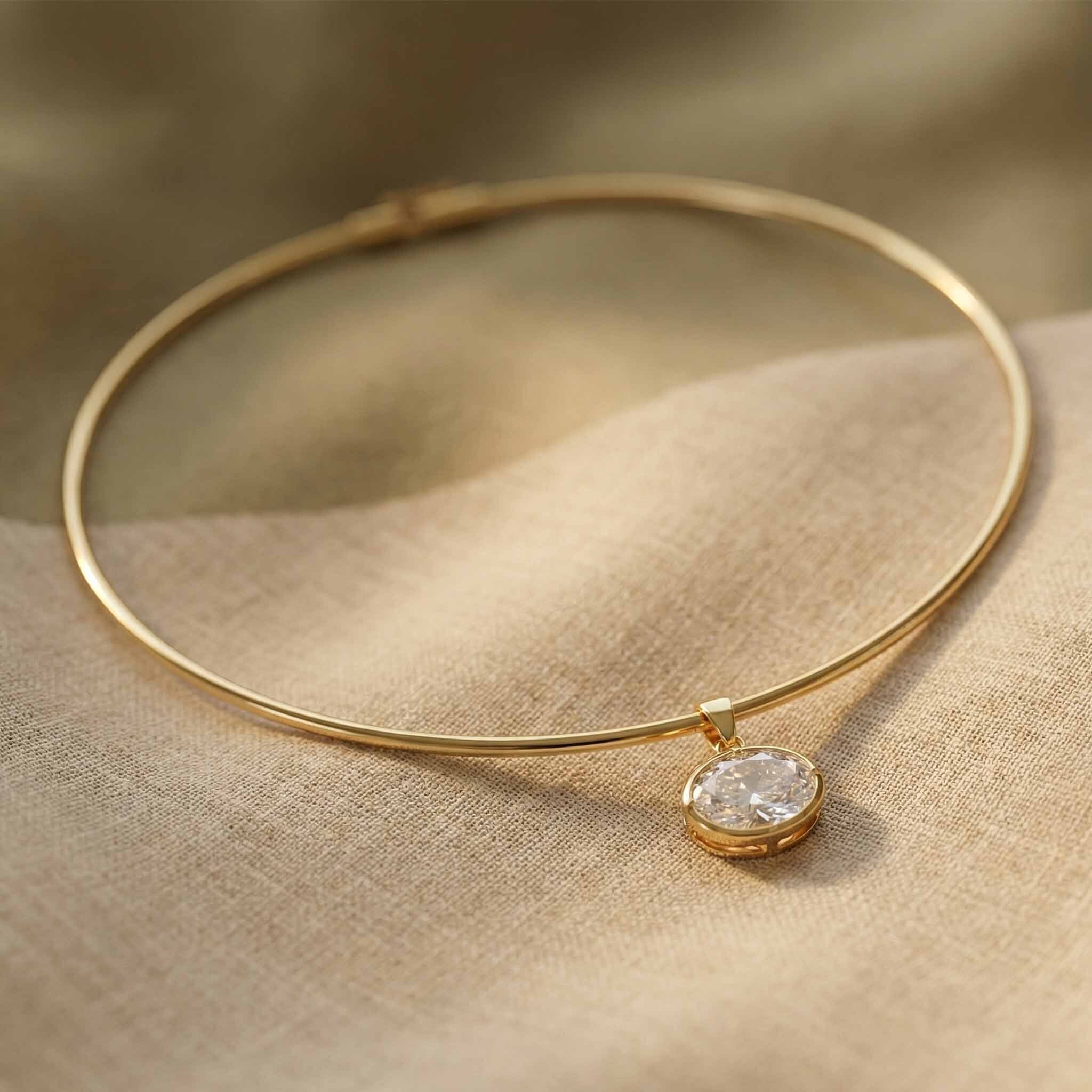 Gold necklace for women with a diamond pendant on a beige fabric background