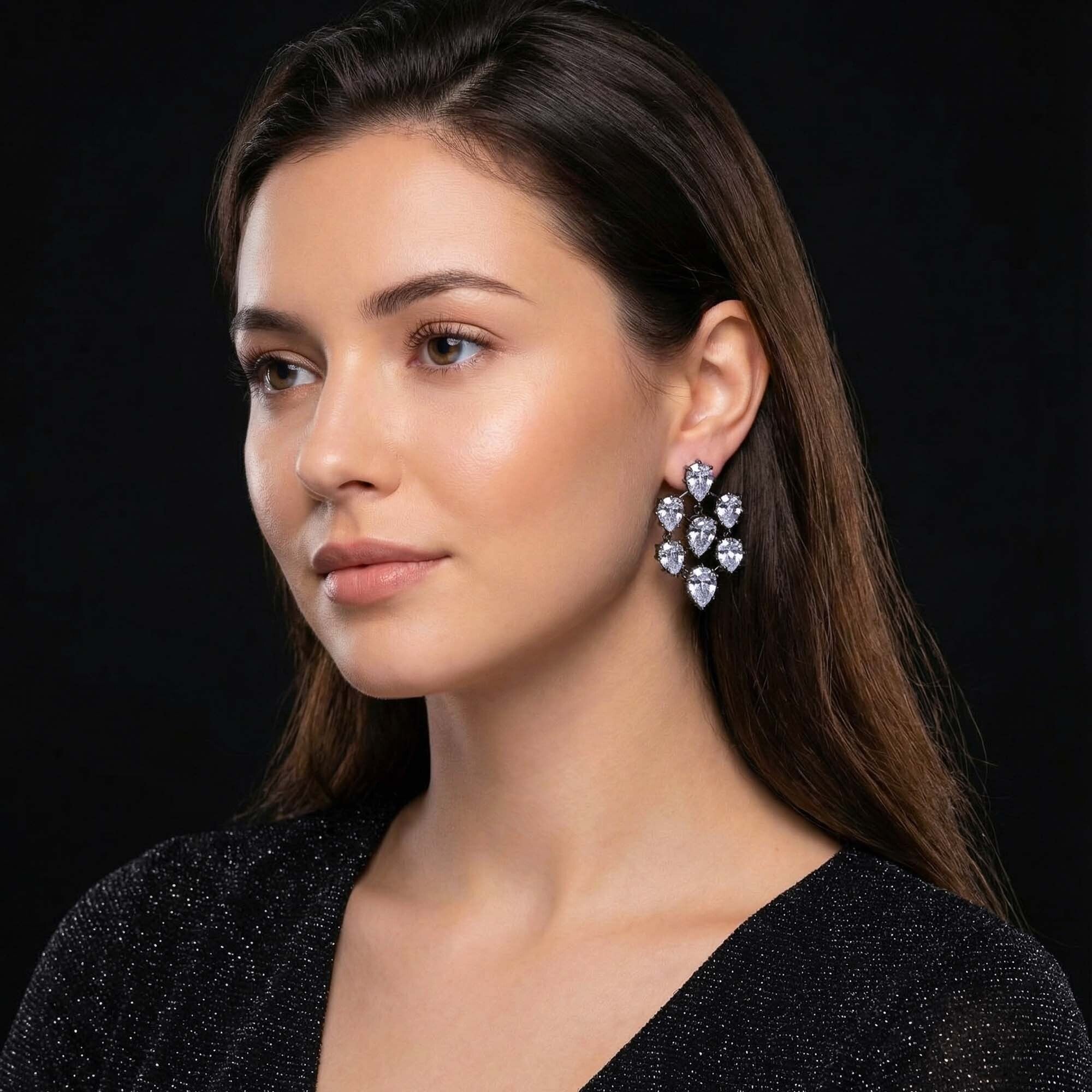 Woman wearing a pair of heart-shaped earrings for women against a black background