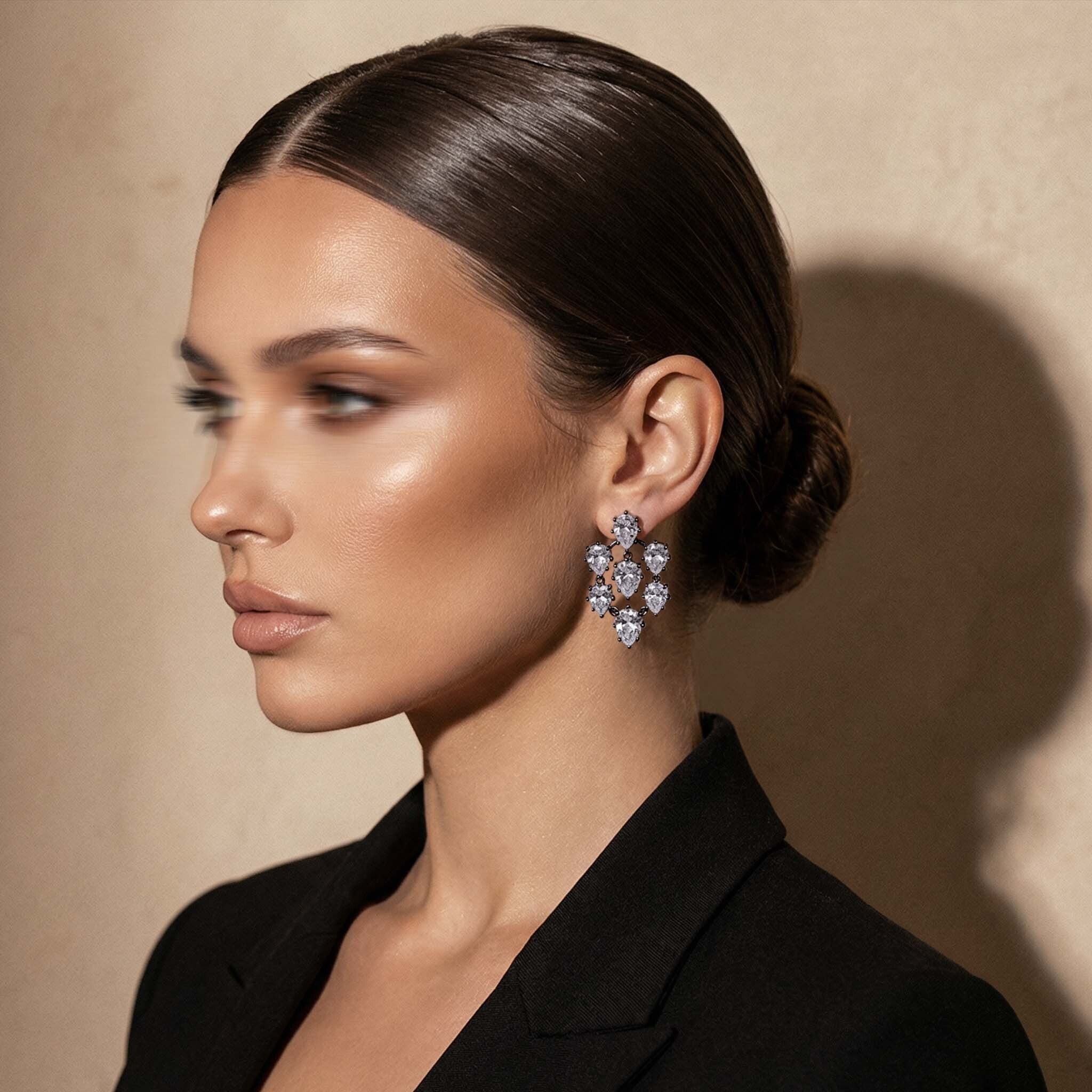 Woman wearing elegant earrings with a neutral background