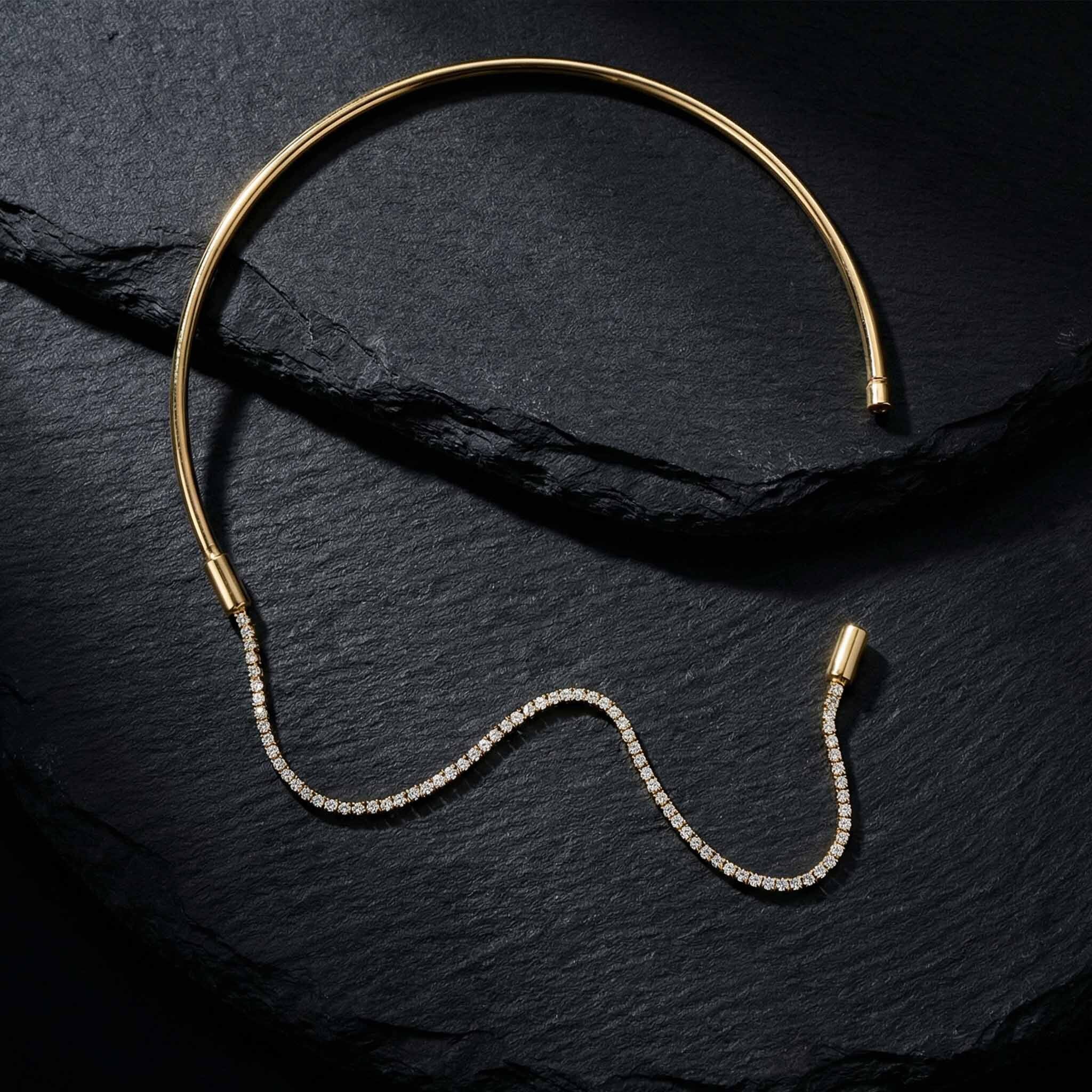 Gold necklace with diamond chain on a dark slate surface