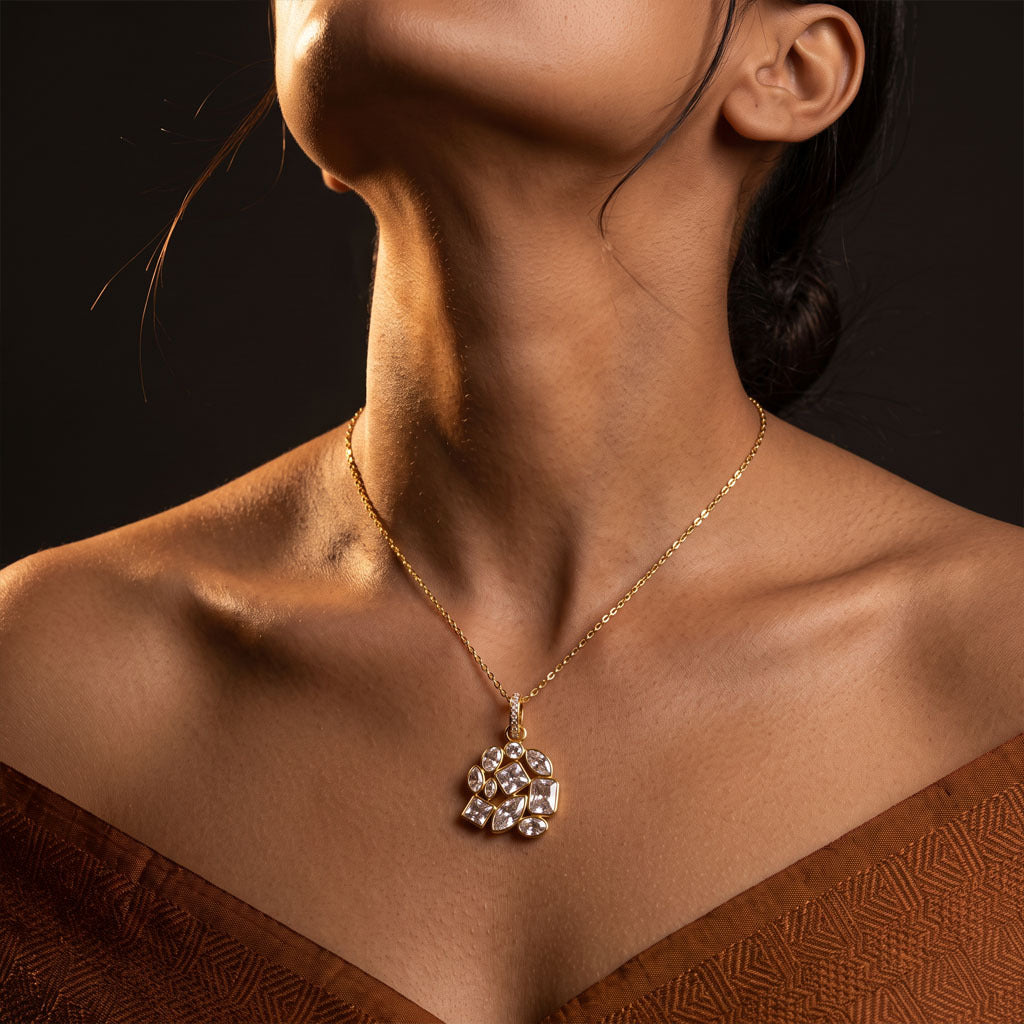 gold chain necklace with a floral cluster pendant 