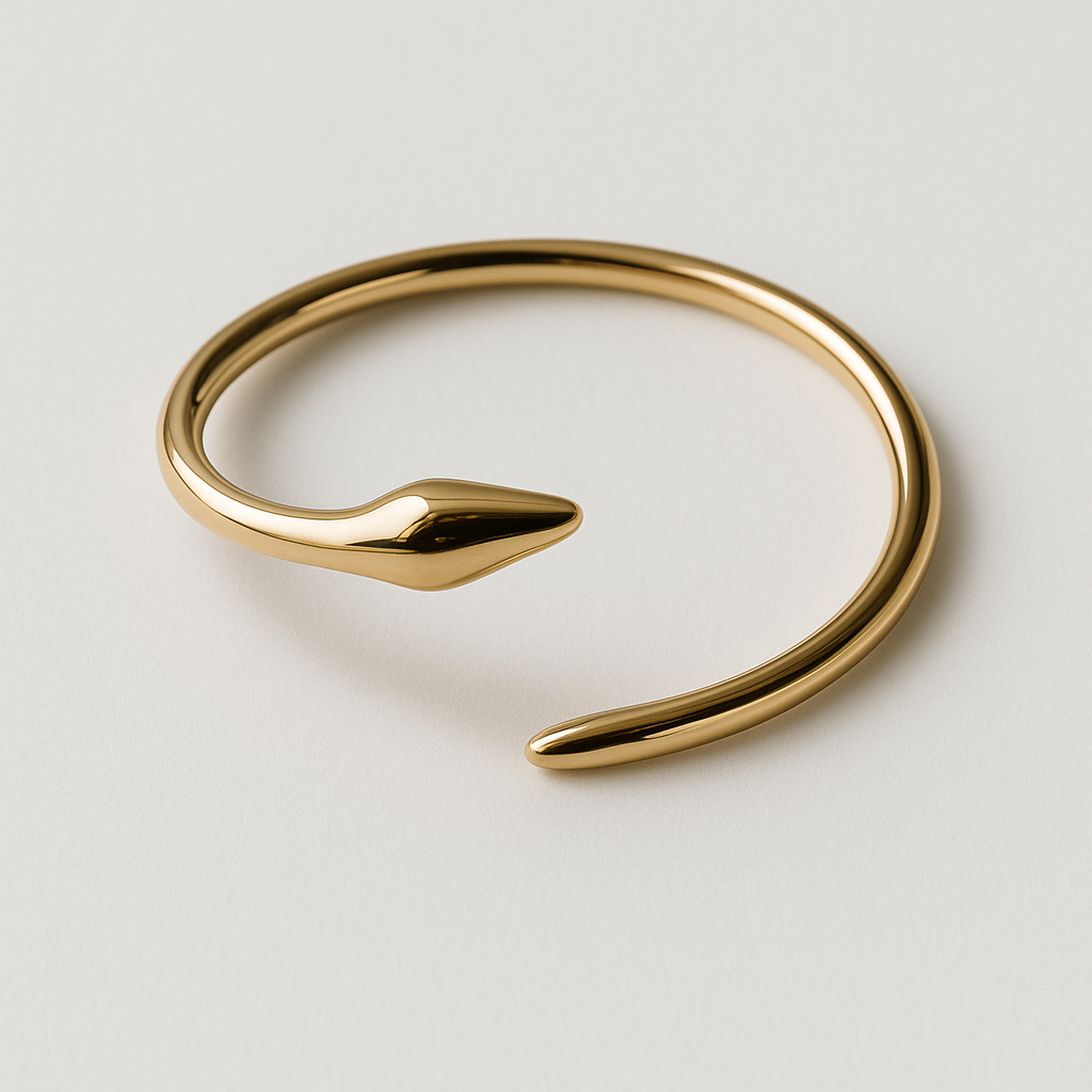 Gold bracelet on a light gray 