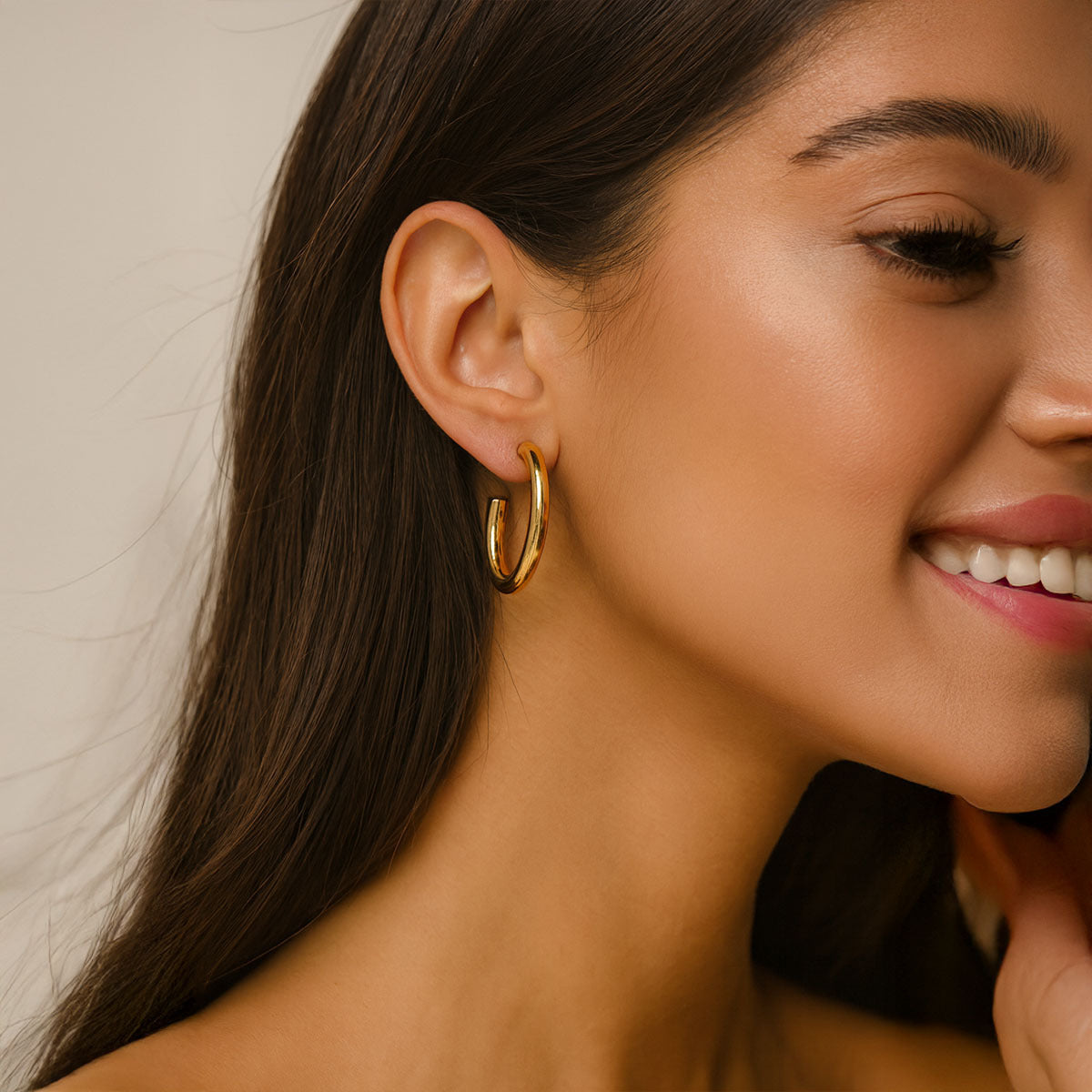  gold hoop earrings with a neutral background