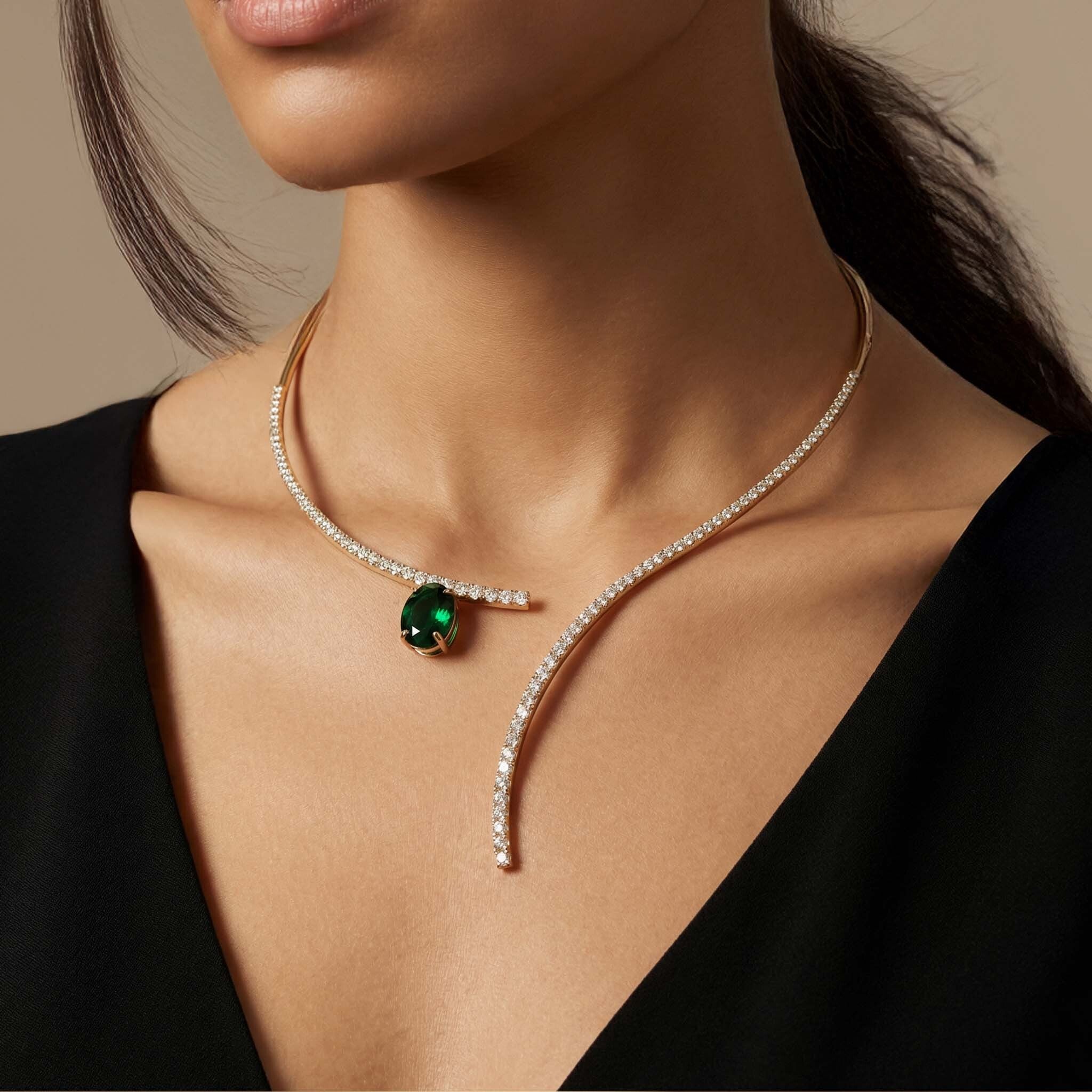 gold_necklace_for_women_lightweight_daily_wear with a green gemstone worn by a model against a neutral background