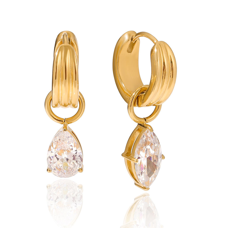 Gold hoop earrings with teardrop-shaped gemstones on a white background