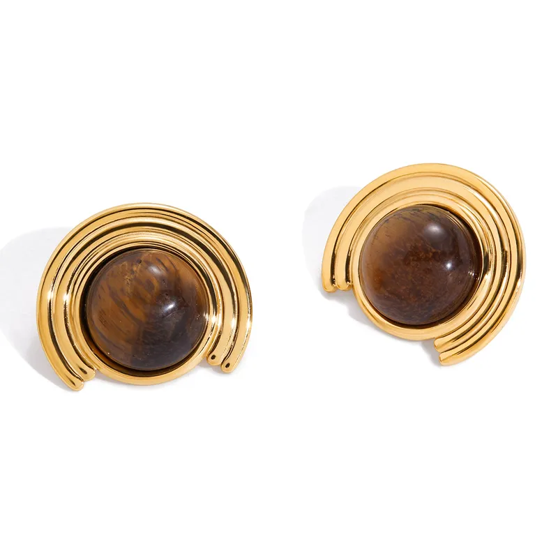 Pair of gold earrings with brown gemstones on a white background
