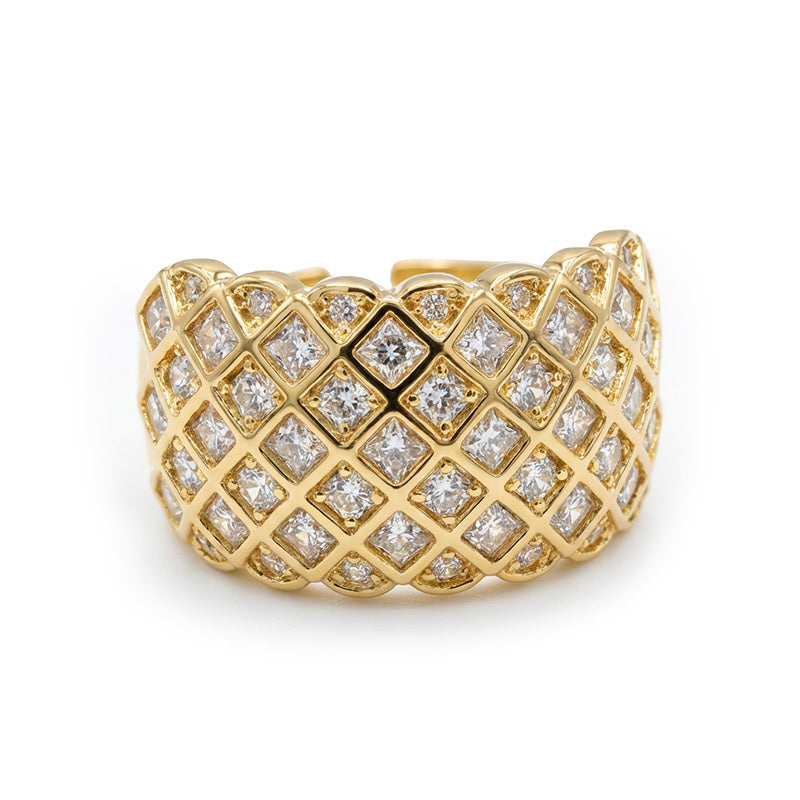 Gold ring with diamond lattice design on a white background