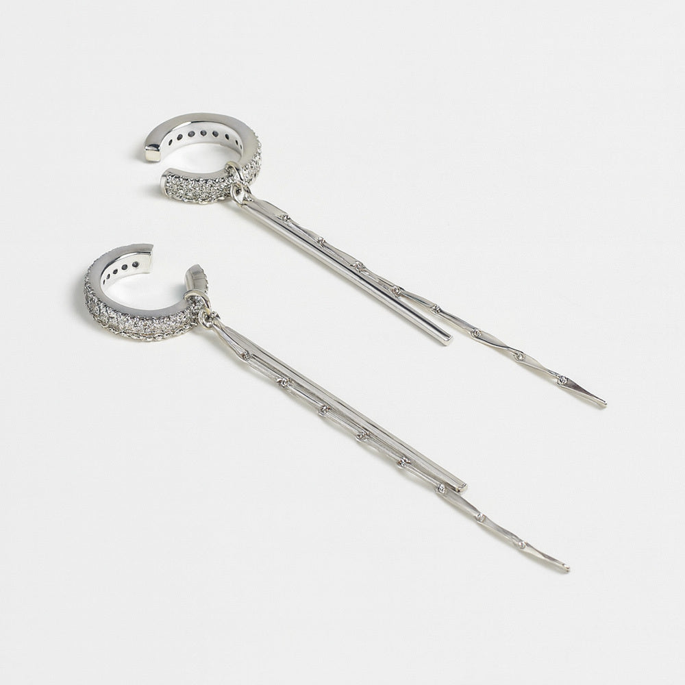 Pair of silver hairpins with intricate designs on a white background