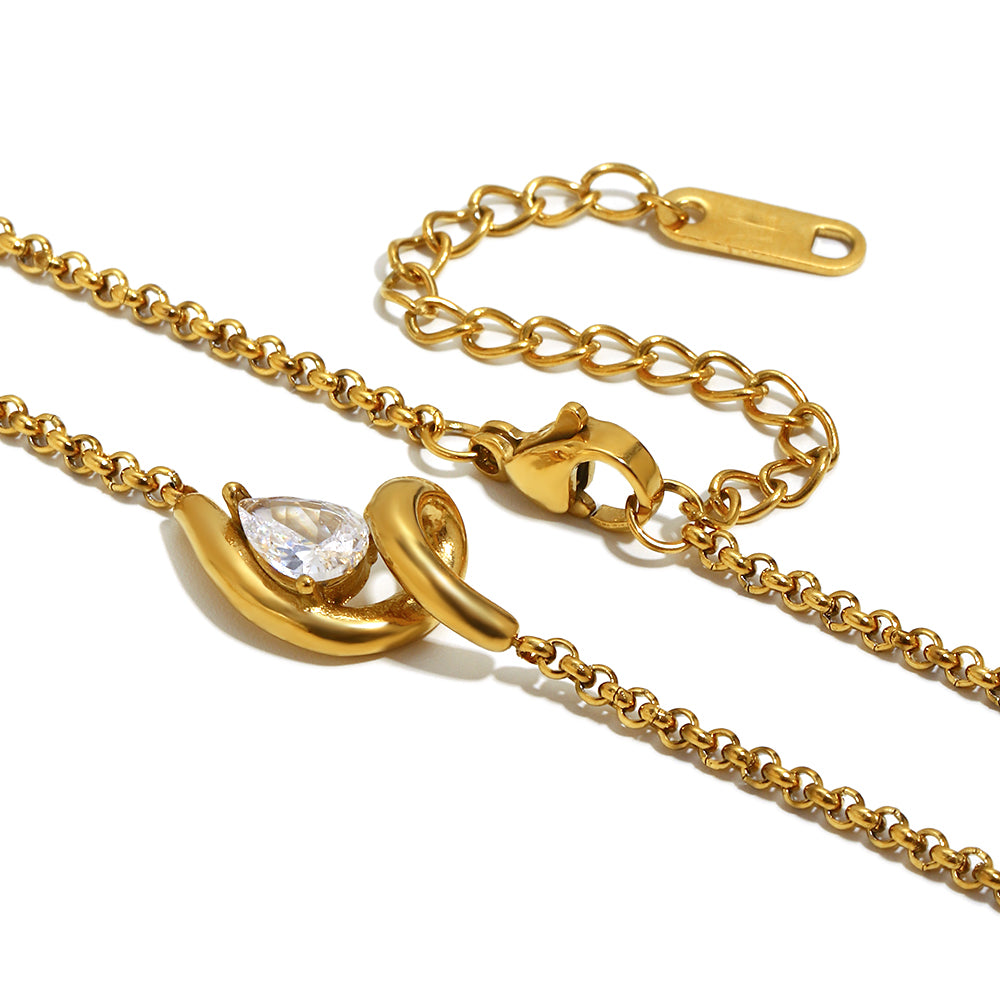 Gold necklace with a teardrop-shaped pendant on a white background