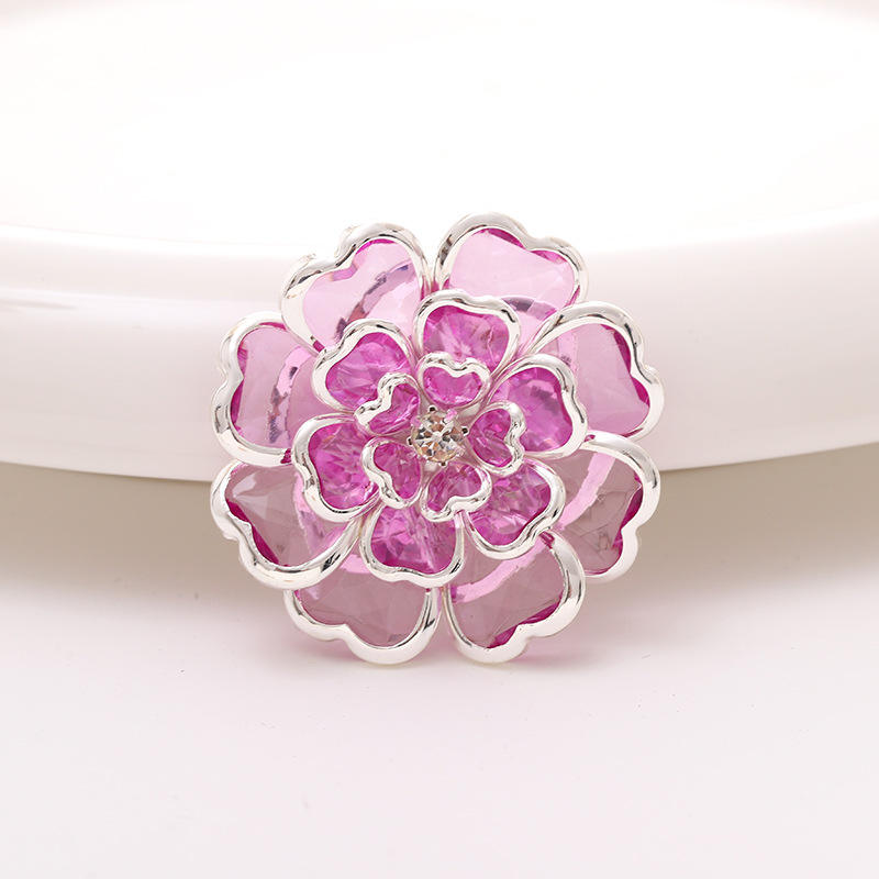 gold floral button with hollow petal design and central stone