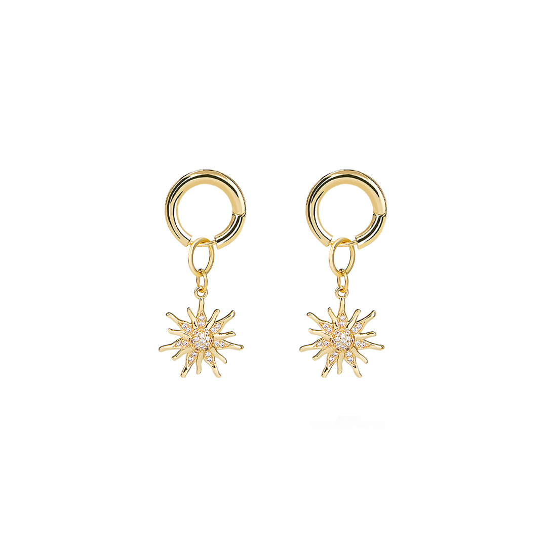 Gold earrings with star-shaped charms on a white background